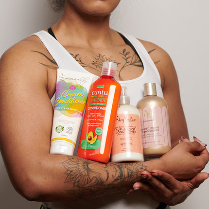 4 conditioners held by a woman